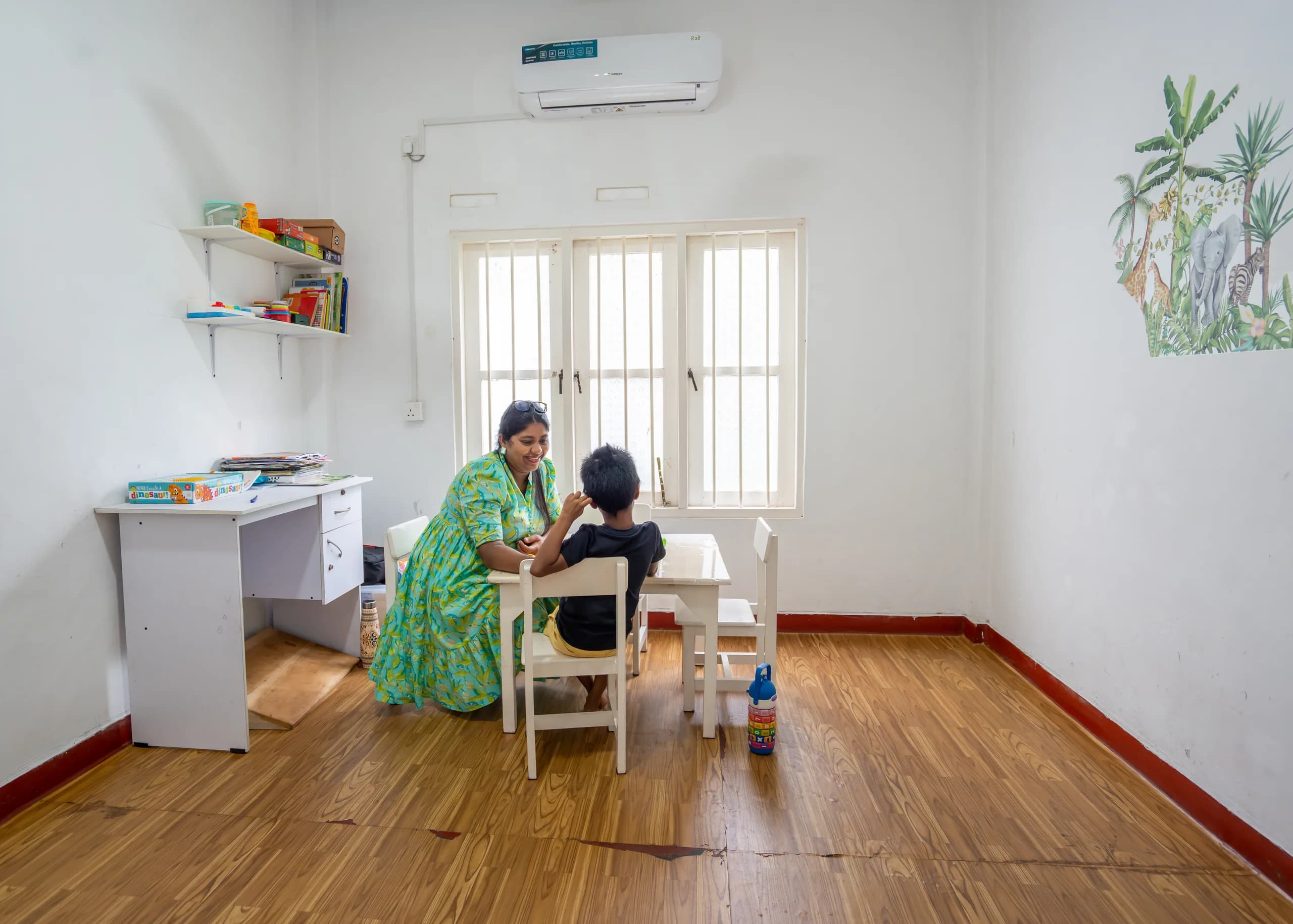 A therapist guiding a child through a hands-on learning activity